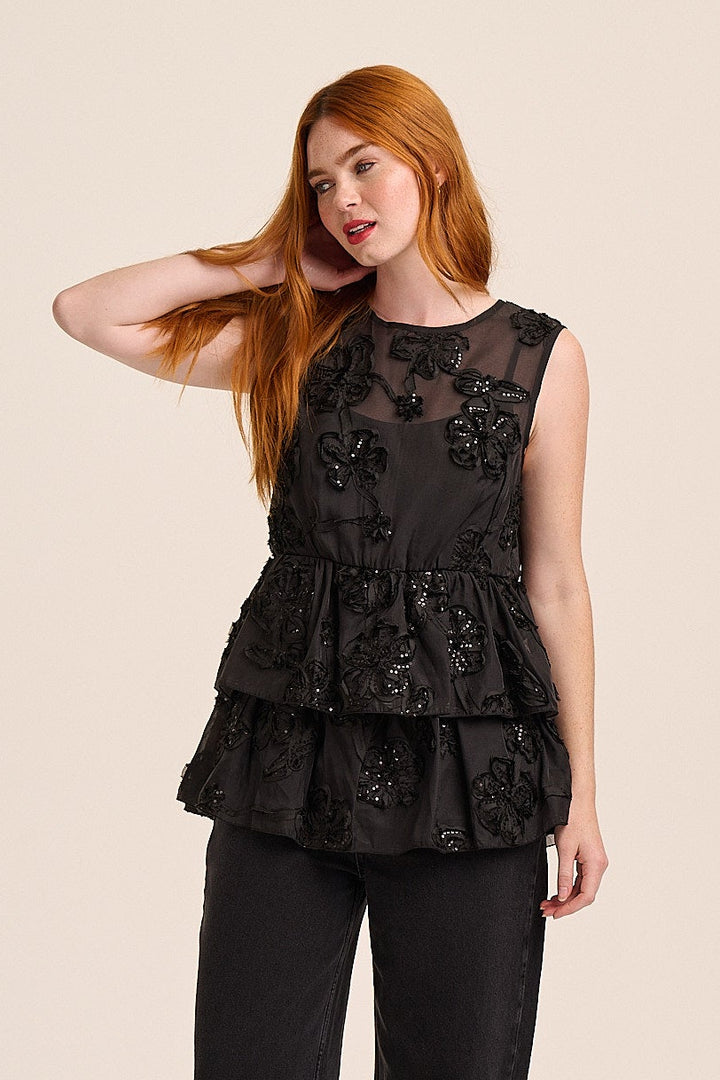 Black sheer top with 3D sequin floral appliqué and tiered peplum — Coco, Mutha.Hood