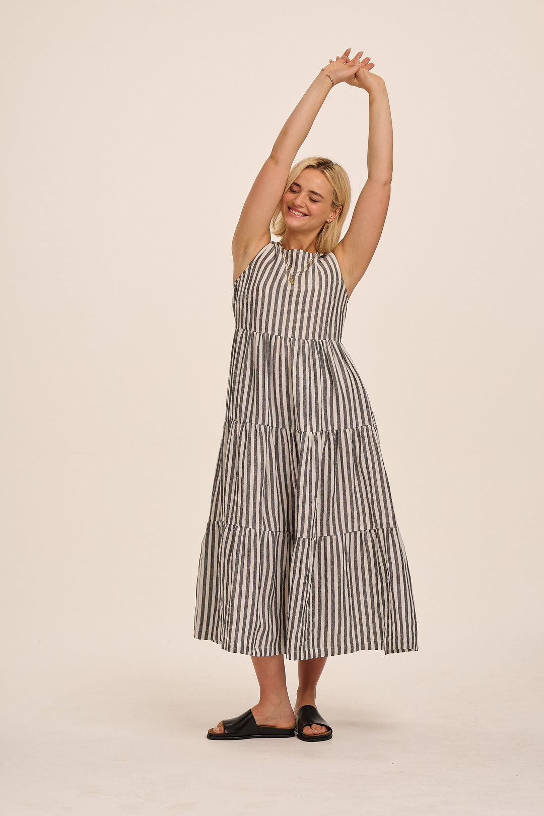 Black and white stripe linen midi dress styled with sandals