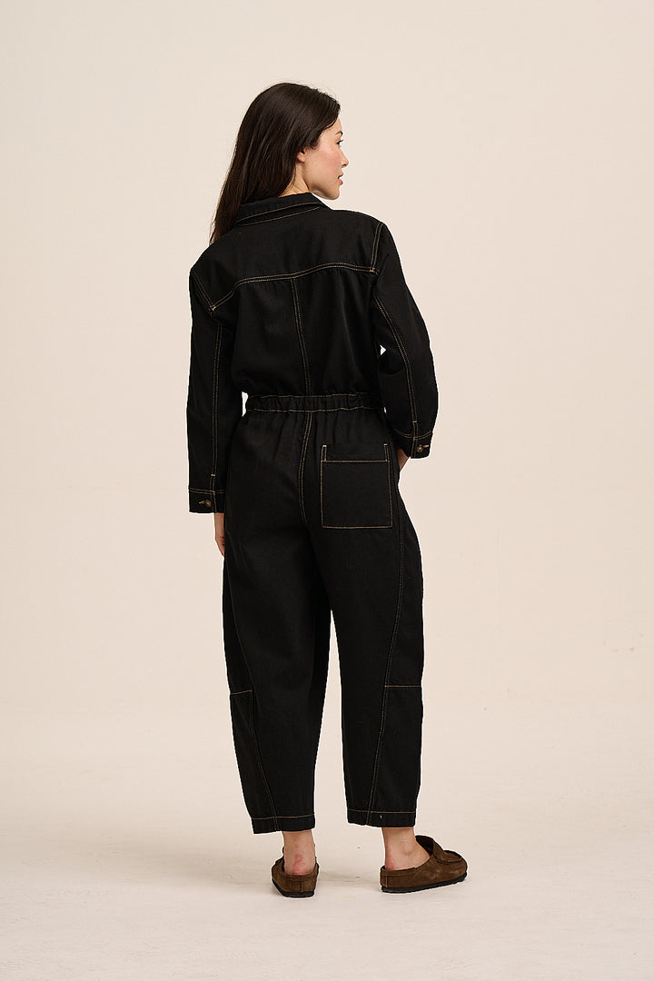 Back view of the Gracie black denim jumpsuit, showing the elasticated back waist and patch pocket