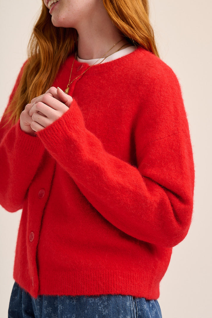 Soft red alpaca cardigan styled with floral denim — Mutha.Hood