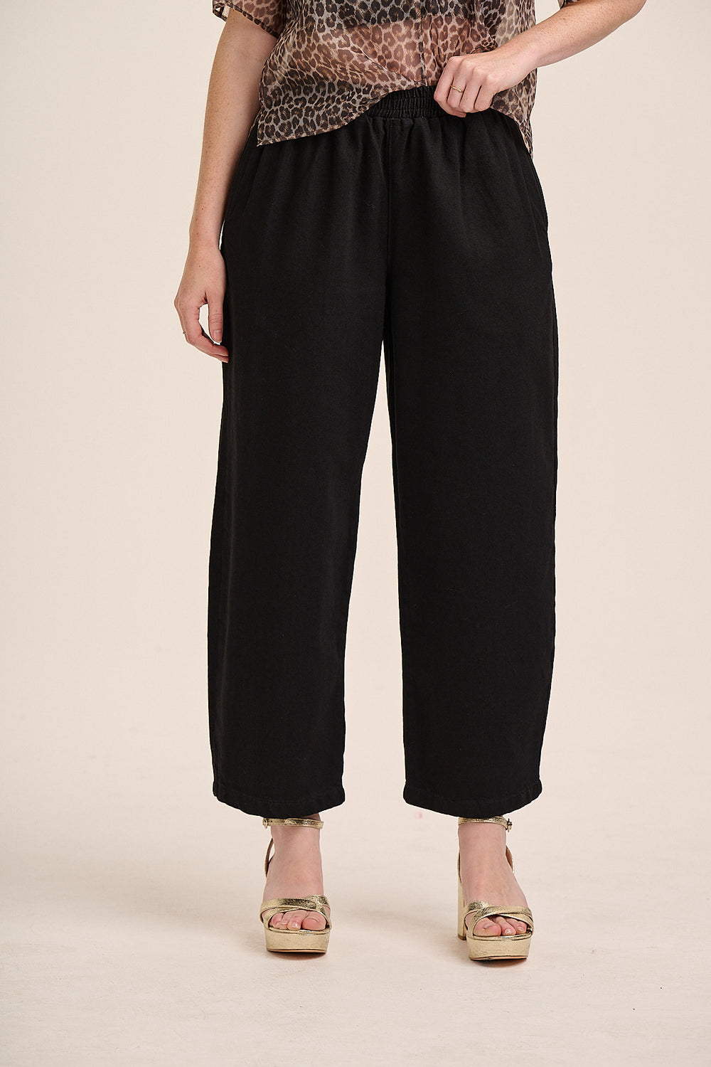 Black elasticated balloon trousers front view — Mutha.Hood